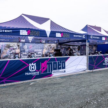 Cat Moto Motocross Team with two Ecotent pop-up gazebos at a European race paddock.
